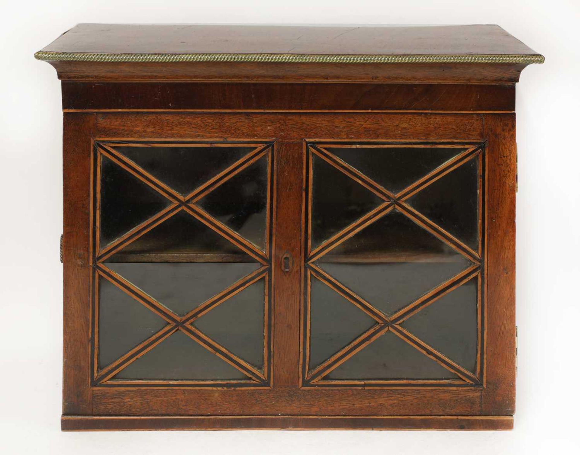 A George III strung mahogany cabinet,