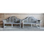 A pair of Lutyens-style weathered teak garden benches,