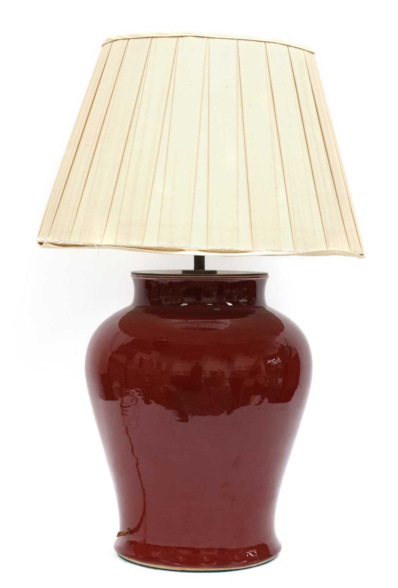 A large Chinese-style red-glazed porcelain table lamp,