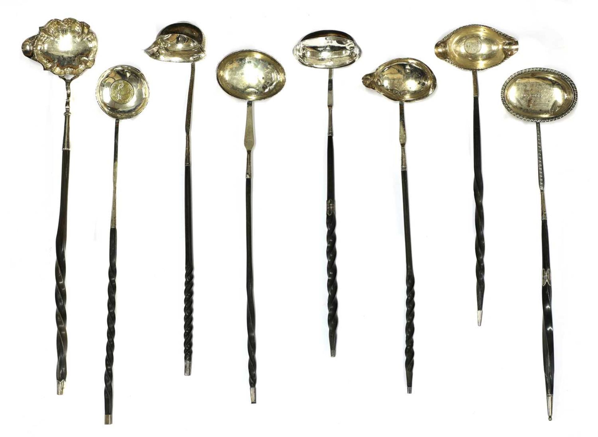 A collection of eight silver toddy ladles,