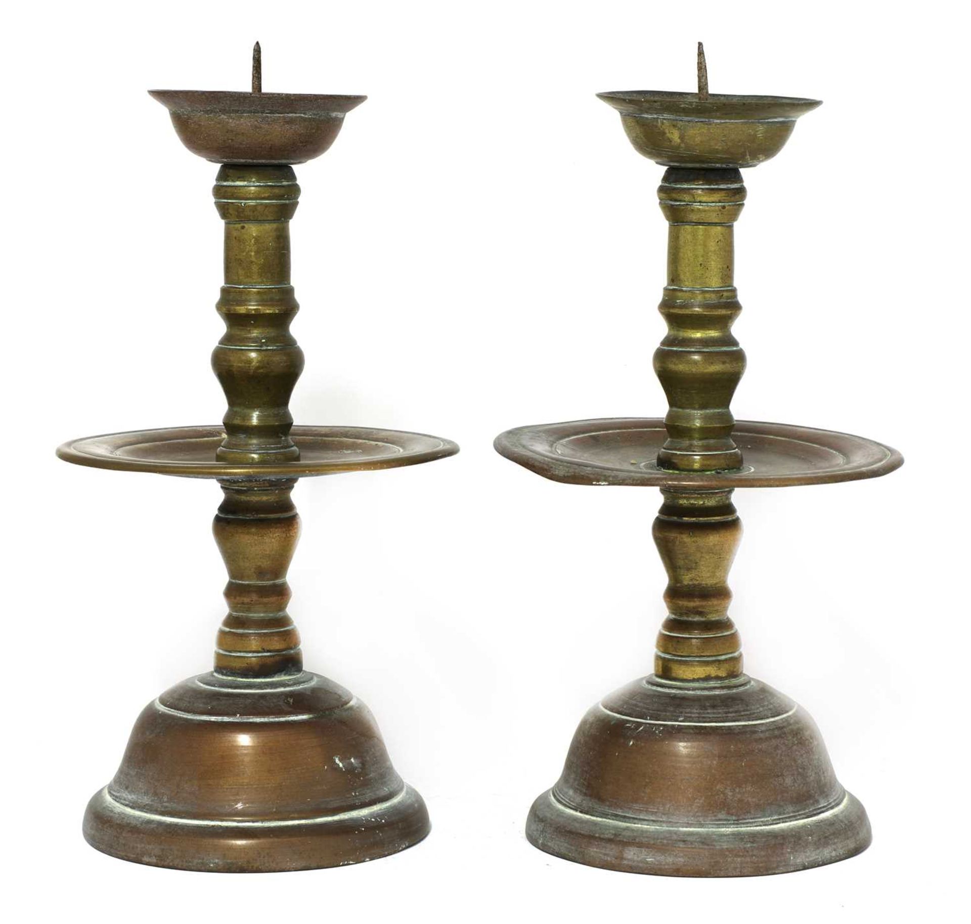 A pair of bronze Heemskerk-type candlesticks,