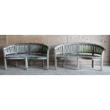 A pair of Lutyens-style curved teak garden benches,