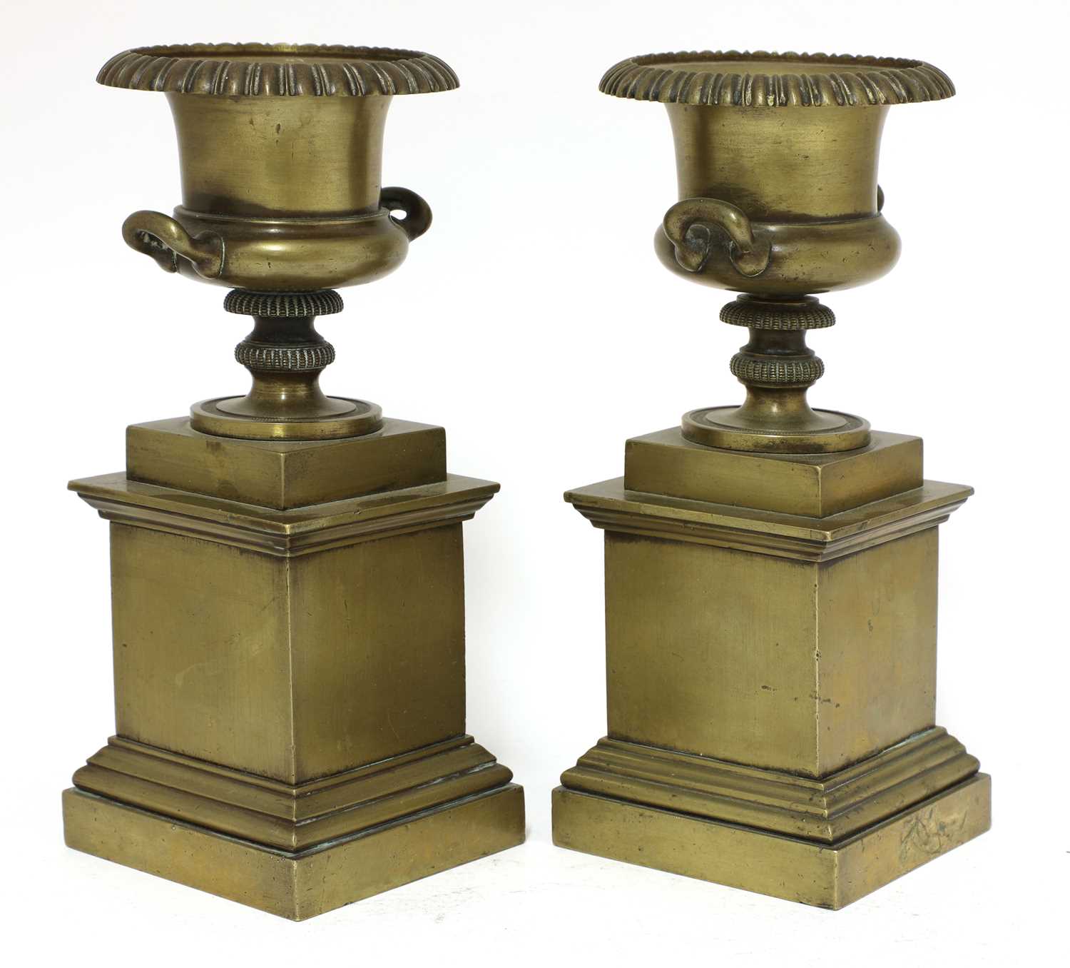 A pair of bronze urns,