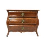 A miniature bombé commode,