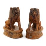 A pair of treacle-glazed pottery lions,