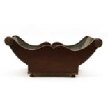 A George III mahogany cheese coaster of boat form,