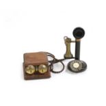 A vintage candlestick telephone,