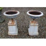 Pair of white painted cast iron garden urns,