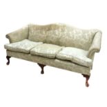 A modern camel back sofa,