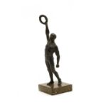 A bronzed figure of an athlete,