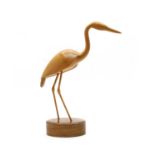 A carved wooden figure of a heron,