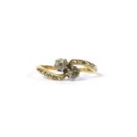 A gold two stone diamond crossover ring,