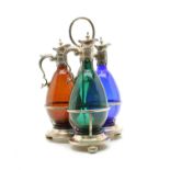 Three coloured glass claret jugs,