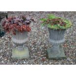 A pair of reconstituted stone campana form garden urns,