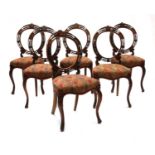 A set of six walnut hoop back chairs,