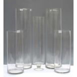 Five tall glass vases,