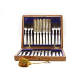 A set of twelve silver mounted and mother of pearl handled dessert knives and forks,