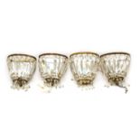 A set of four Edwardian gilt metal and glass basket form wall sconces,