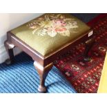 A small mid-18th century mahogany stool with later drop-in needlework floral upholstery, the stool