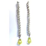 A pair of white gold peridot and diamond earrings, each earring contains 15 princess cut diamonds