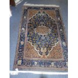 A hand-knotted Persian rug; stylised tree-of-life design against a cobalt-blue lozenge with beige