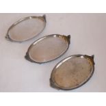 Three heavy hallmarked silver two-handled oval platters of small proportions, each with gadrooned