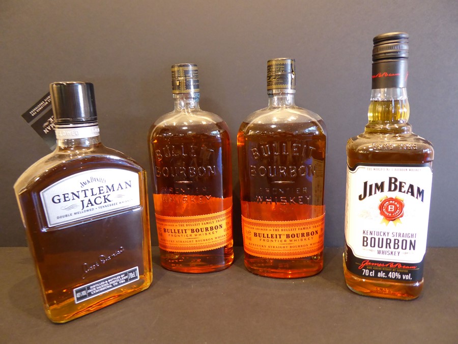 Three bottles of Kentucky and one bottle of Tennessee whiskey: 2 x Bulleit Bourbon, 1 x Jim Beam and