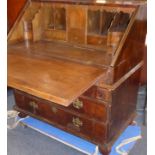 An early to mid-18th century walnut writing bureau; the quarter-veneered crossbanded fall opening to