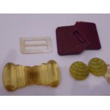 A small selection of buckles etc. to include a circa 1930s mother of pearl example, an early plastic