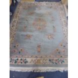 A large turquoise ground Chinese 100% thick woollen carpet, the central mon with flower head