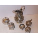 Eastern silverware to include a heavy baluster-shaped jug with a central band of Arabic/Indian