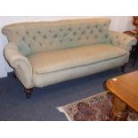 A large 19th century damask-upholstered walnut Chesterfield sofa; raised on short turned tapering