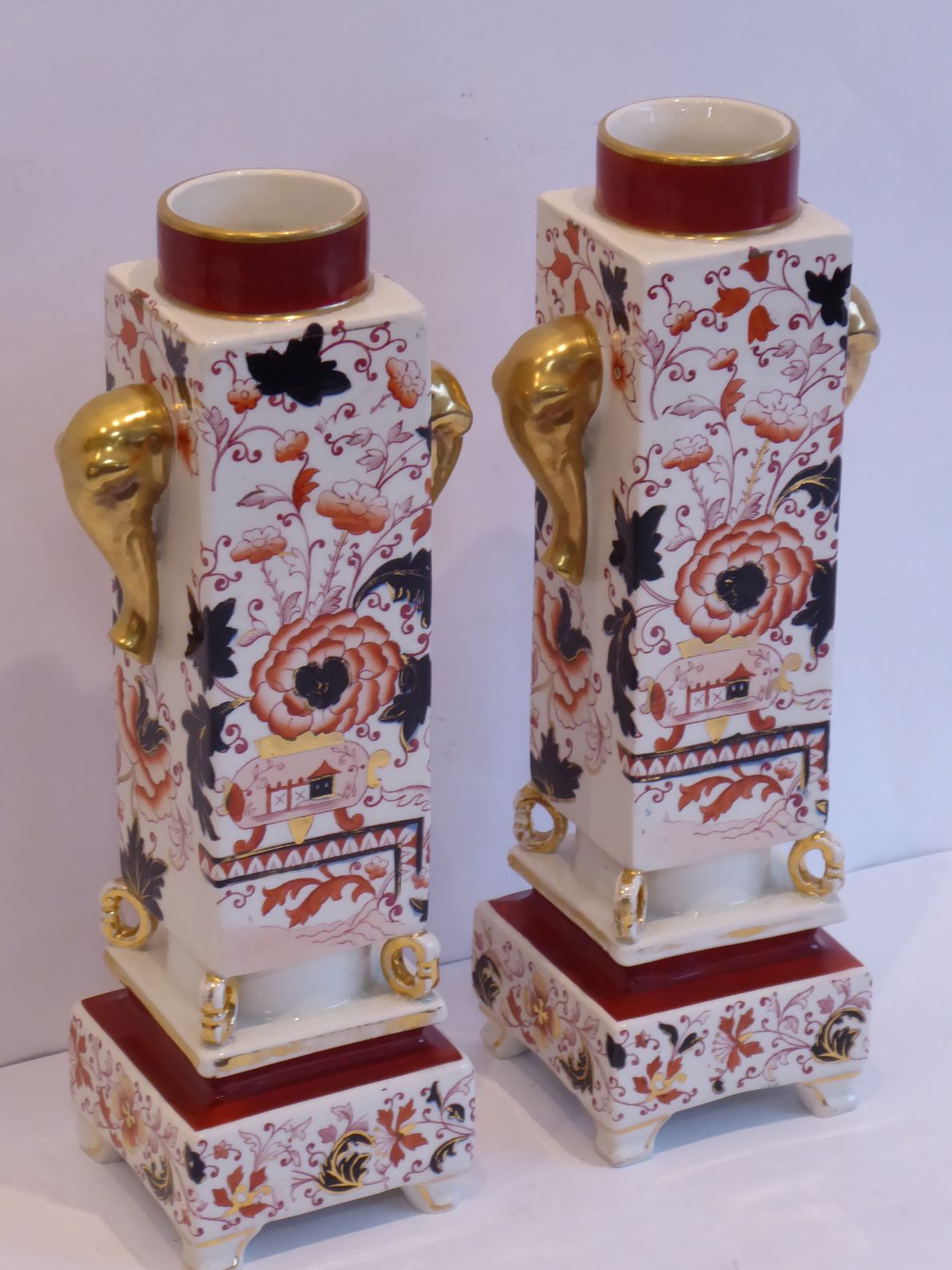 A pair of late 19th century pottery vases hand-gilded and decorated in the Imari palette; each