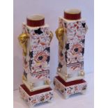 A pair of late 19th century pottery vases hand-gilded and decorated in the Imari palette; each