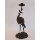 A late 19th century patinated bronze candlestick modelled as a stork upon a lotus leaf with a turtle