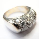 A heavy 18 carat white gold ring set containing 17 diamonds