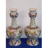 A pair of early 20th century Delftware pottery vases in earlier Persian style; thistle-shaped