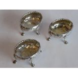 Three hallmarked silver Georgian salts of oval form; repoussé decorated with flowers and vacant