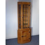 Robert 'Mouseman' Thompson, a free-standing oak corner cupboard, single leaded-light glazed door