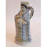 An unusual French faience jug modelled as a standing figure in robes and carrying a bottle flask;