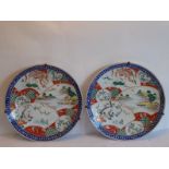 A pair of late 19th century Japanese porcelain chargers; hand-decorated in typical style with panels