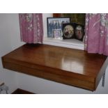 An unusual 1960s/70s Scandinavian style horizontally wall mounted two-drawer rosewood shelf unit,