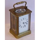 A late 19th / early 20th century brass and glass-sided carriage clock, white-enamel dial with