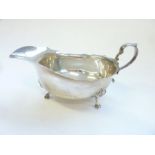 A Georgian-style Mappin & Webb hallmarked silver sauce-boat on three shaped feet