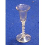 An 18th century wine glass; inverted bell-shaped bowl above an opaque double-spiral-twist stem and