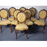 A set of eight mid-19th century walnut button-back upholstered salon chairs; the tightly carved