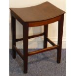 A George III period mahogany stool having saddle seat and square tapering legs united by stretchers,