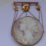 A fine circular cameo brooch-pendant, 9-carat rose-gold mounts with central flower head flanked by