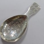 A hallmarked silver caddy spoon by Liberty & Co., London; engraved with basket-weave and cross