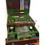 An early 20th century mahogany-cased silver flatware and cutlery service; maker's label of Harrods